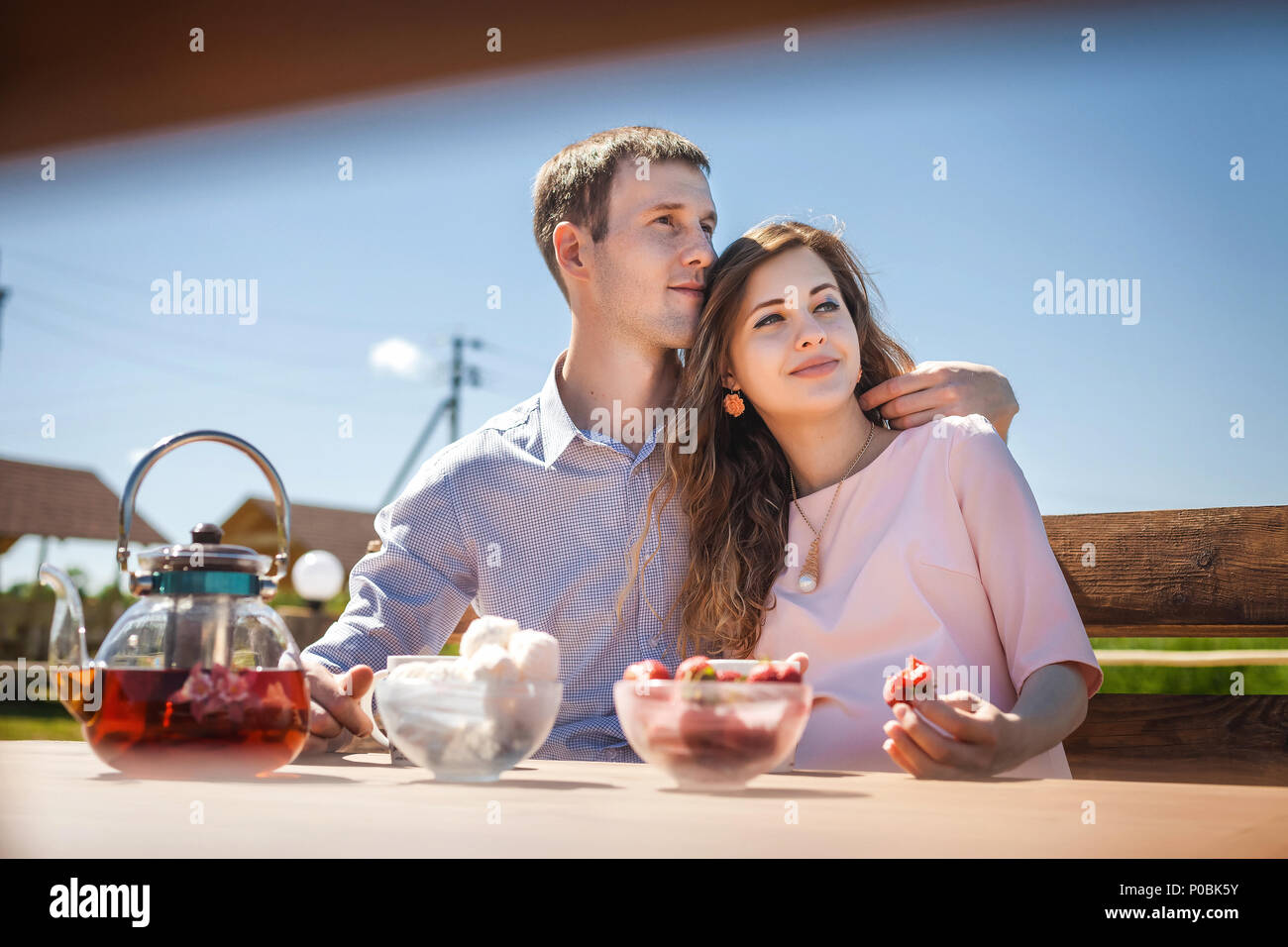 future parents eating strawberry outdoors Stock Photo