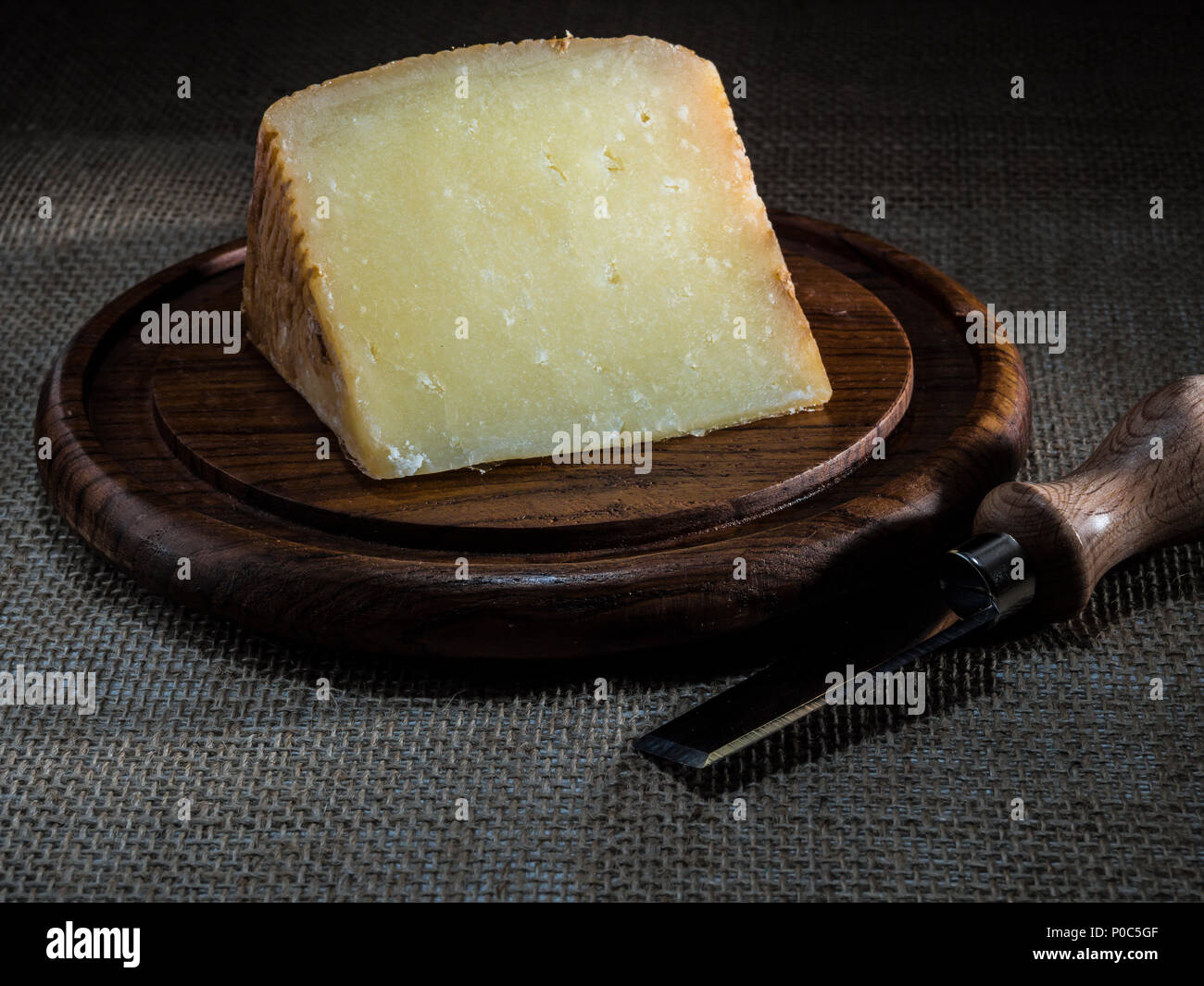 pecorino calabres cheese on wooden plate with cheese knife Stock Photo