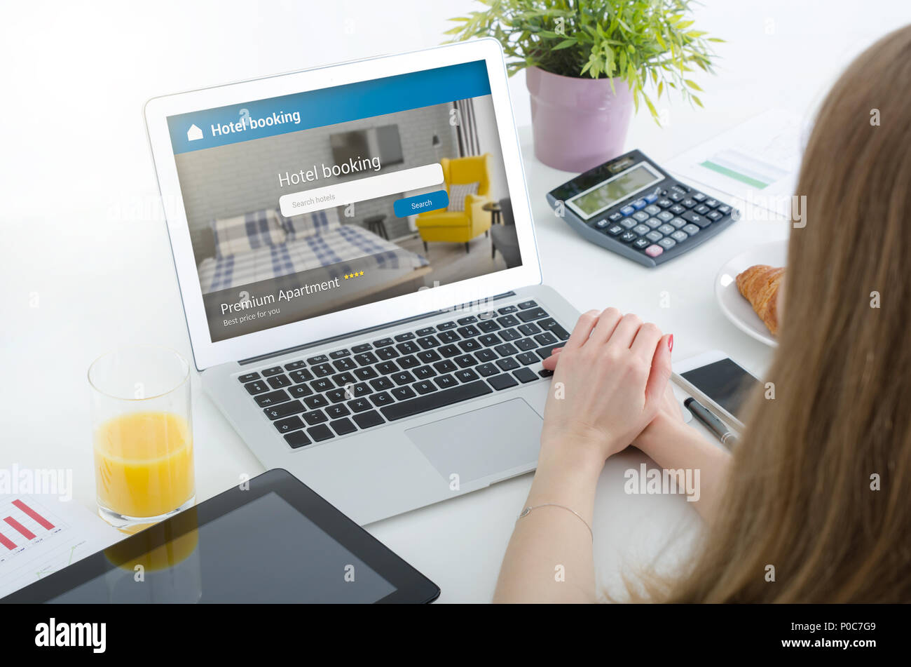Person booking hotel room on laptop. Premium apartment reservation concept. Stock Photo