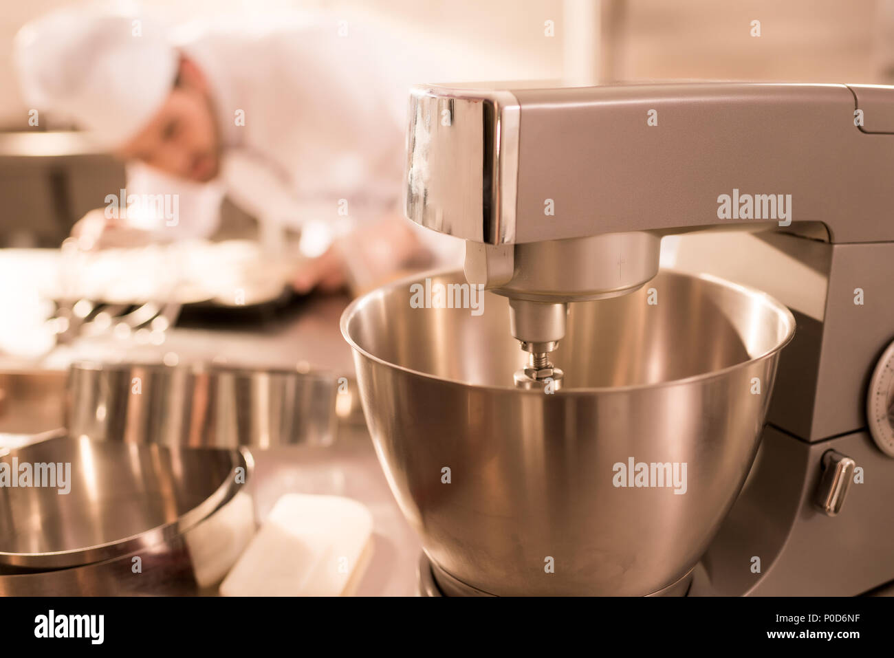 selective focus of confectioner and food processor whipping cream Stock Photo