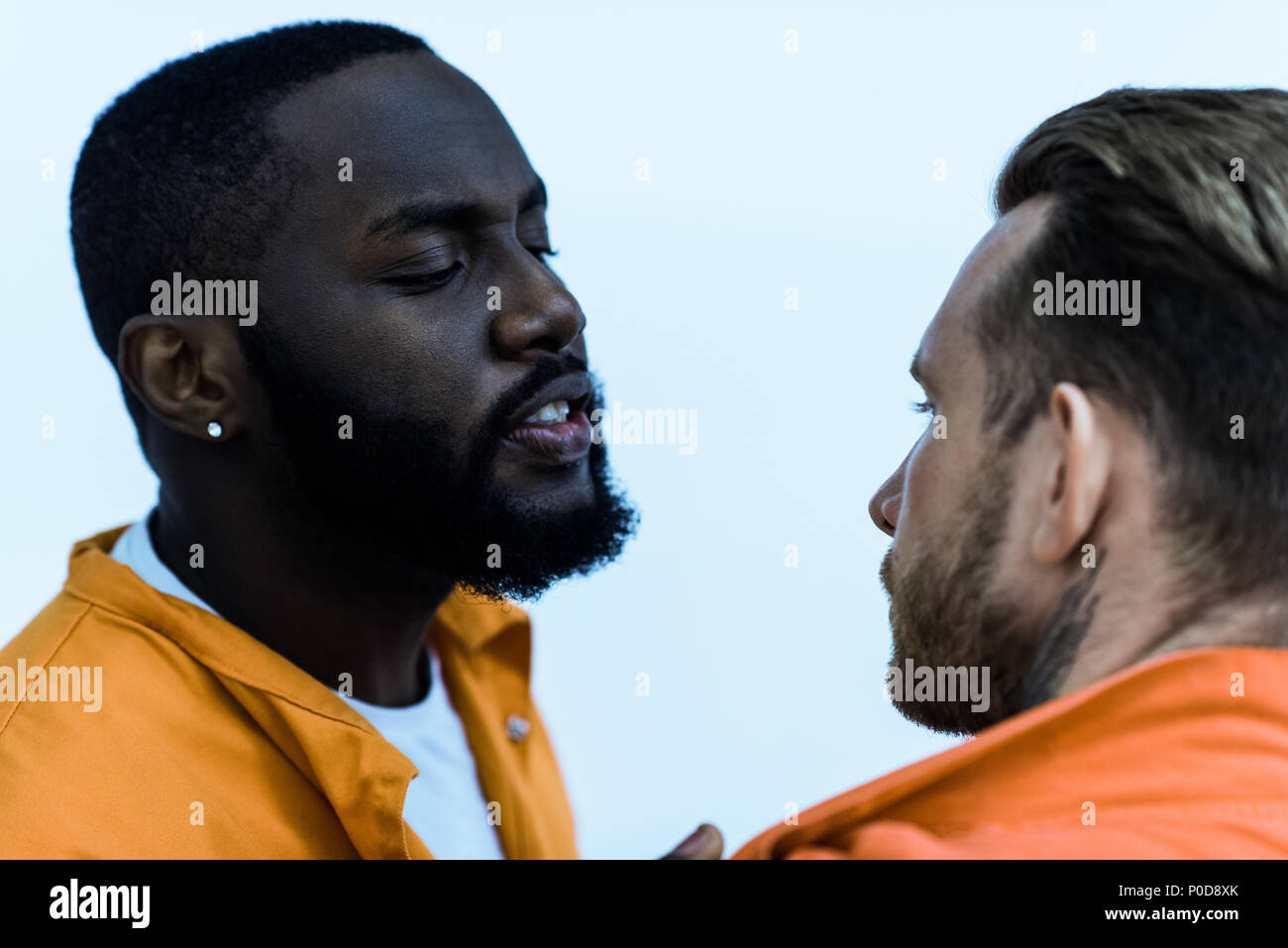 african american prisoner threatening cellmate isolated on white Stock Photo