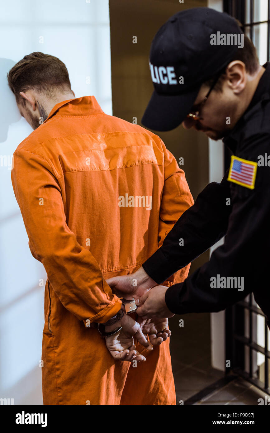 prison guard wearing handcuffs on prisoner Stock Photo Alamy