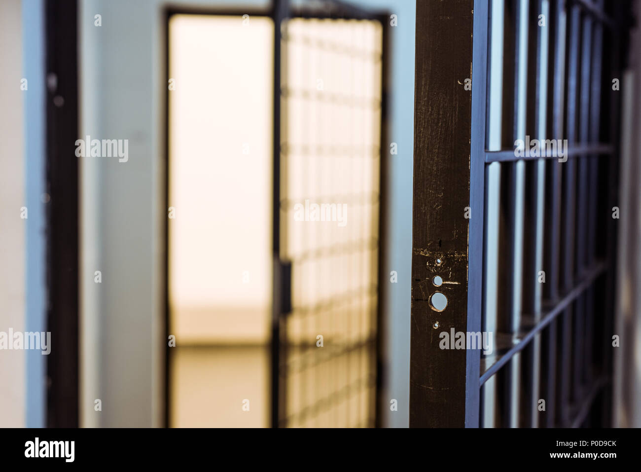 prison bars and empty prison cell Stock Photo