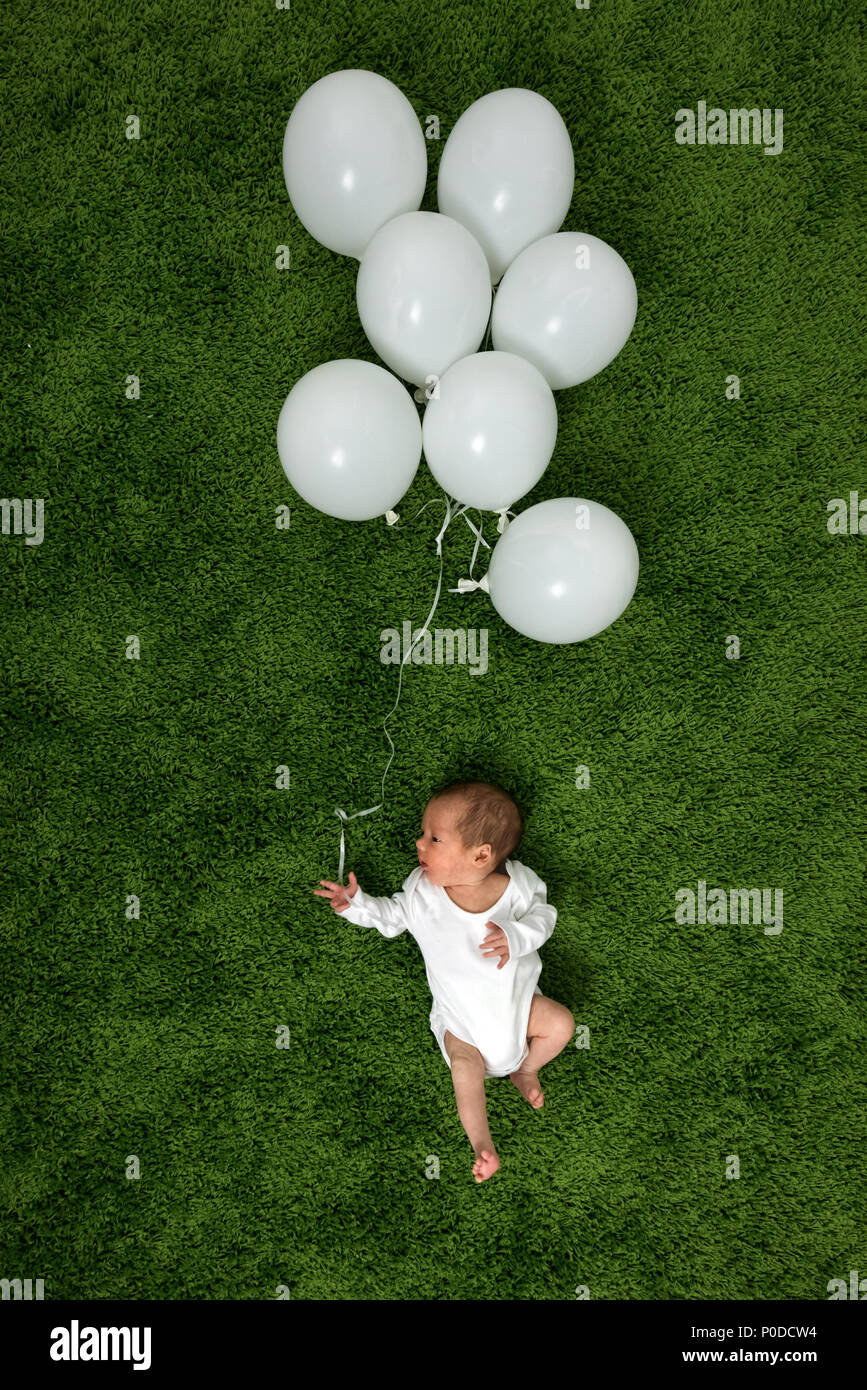 Newborn baby on green carpet Stock Photo