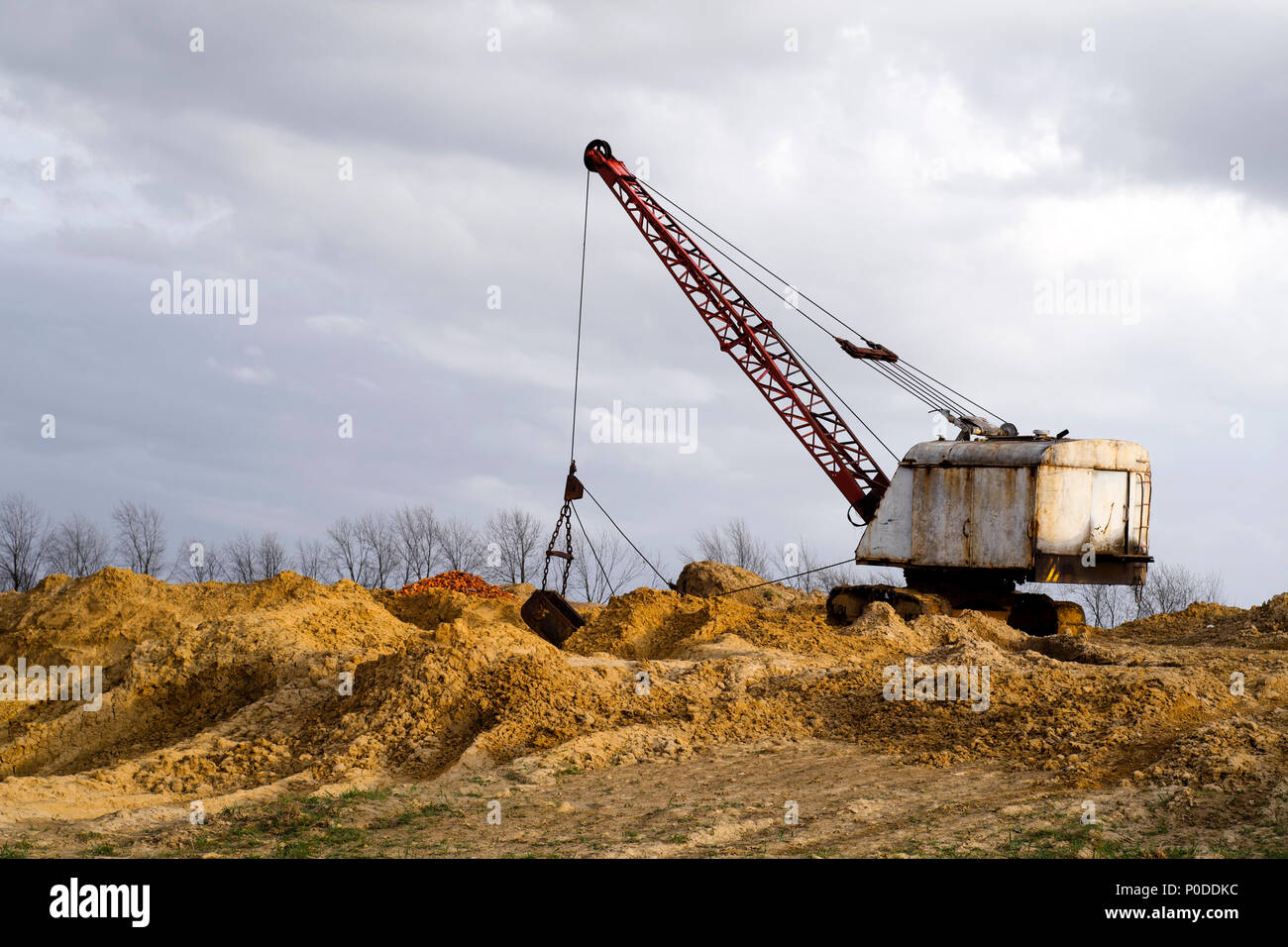 Excavators in the red clay quarry Stock Photo