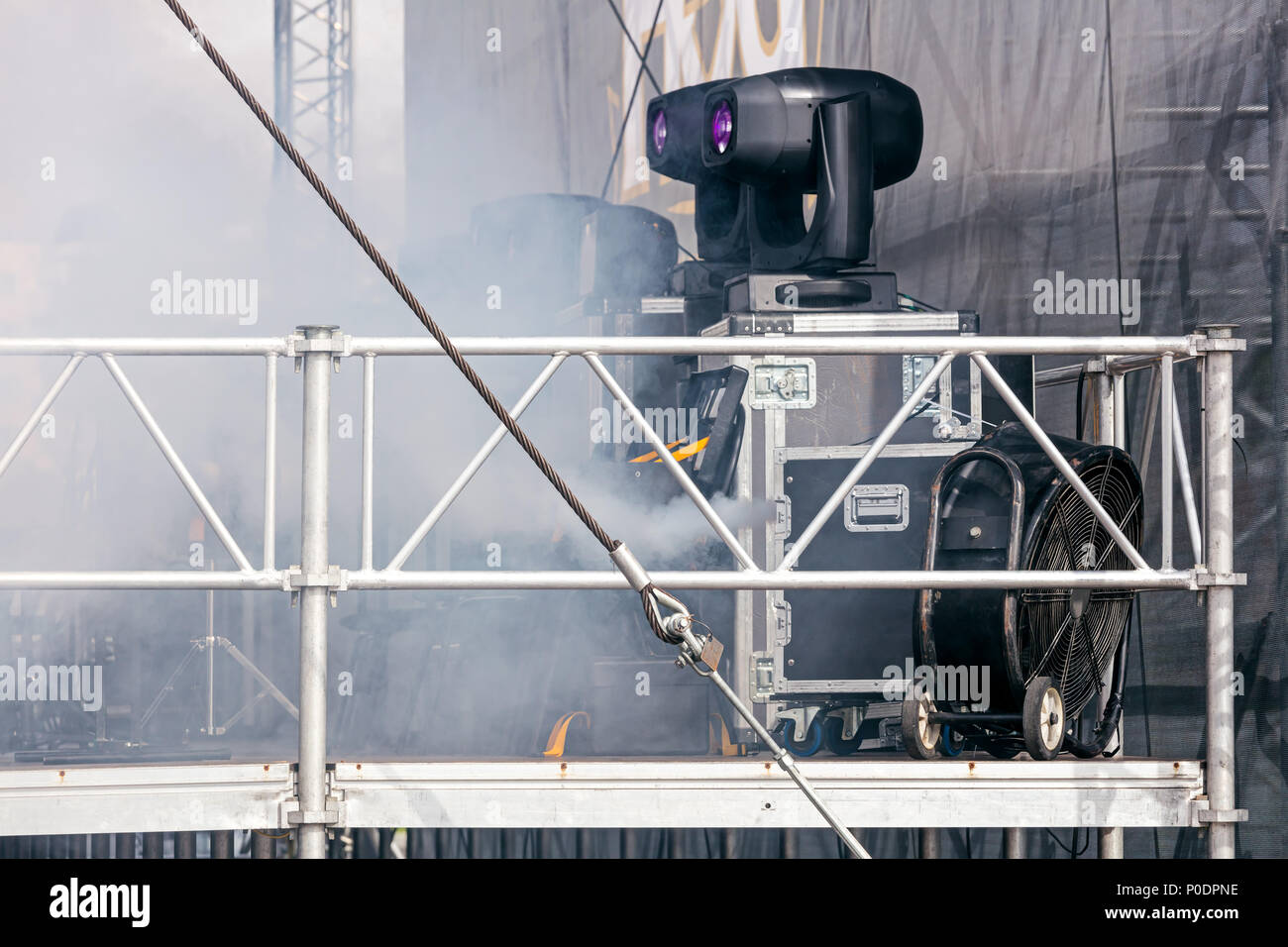 Spotlight Machine professional spotlights and smoke machine on street stage before ...