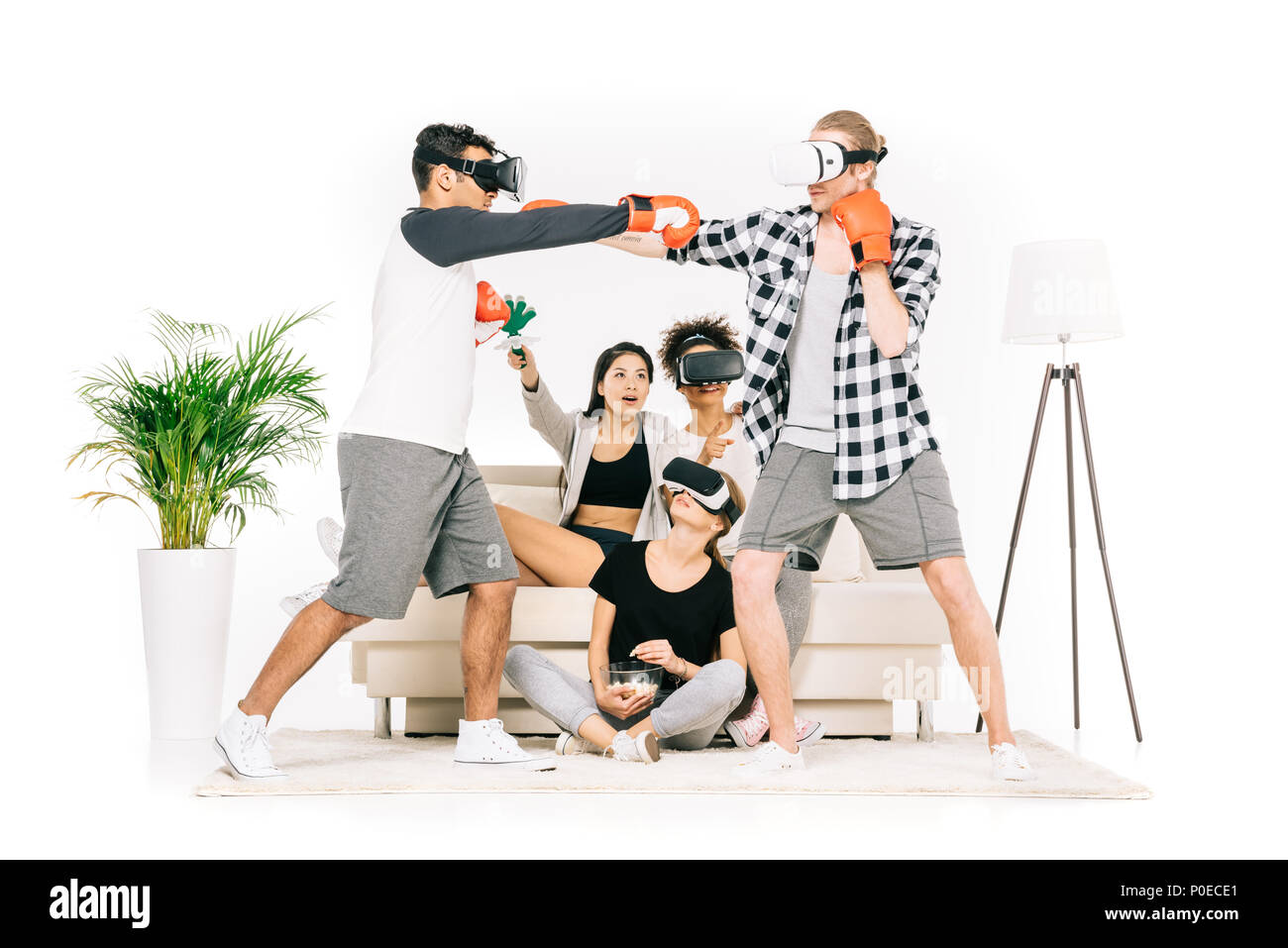 multiethnic young men in virtual reality headsets boxing isolated on