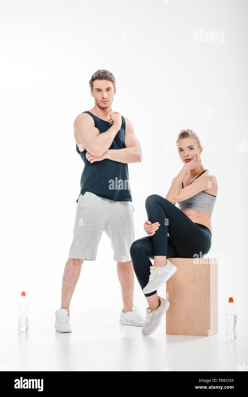 young fit couple posing isolated on white Stock Photo - Alamy