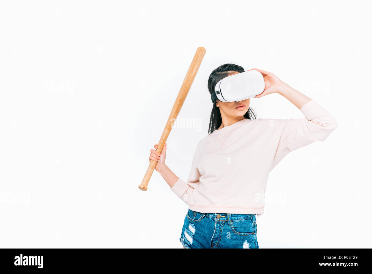 young asian woman in virtual reality headset holding baseball bat