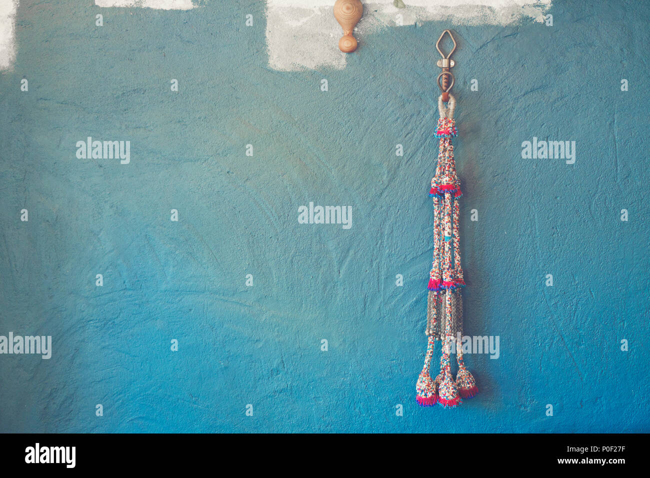 Blue wall background with knitting yarn Stock Photo