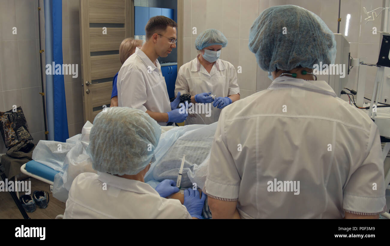Doctors performing endoscopic procedure in hospital Stock Photo Alamy