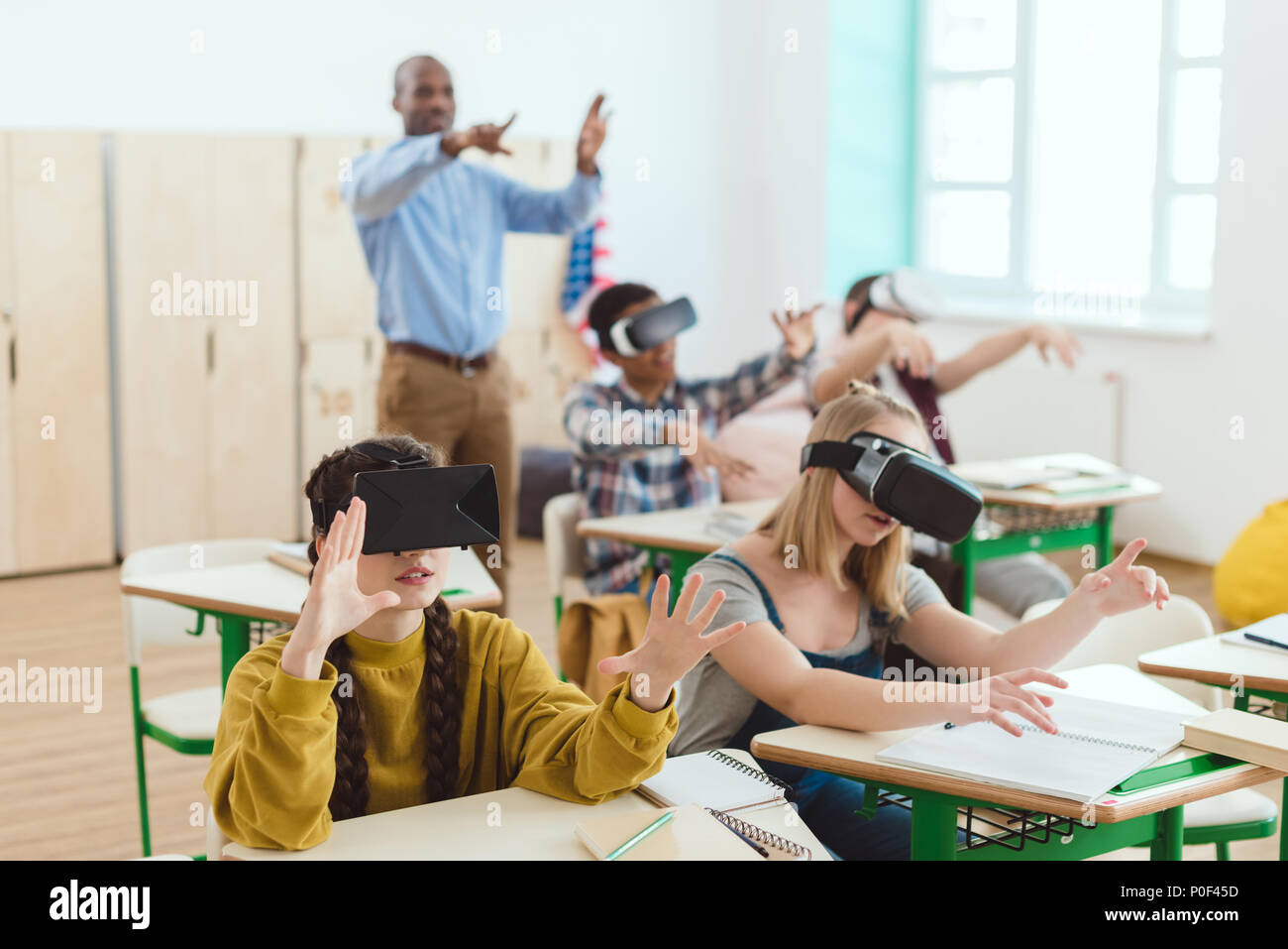 High school teenage students using virtual reality headsets and