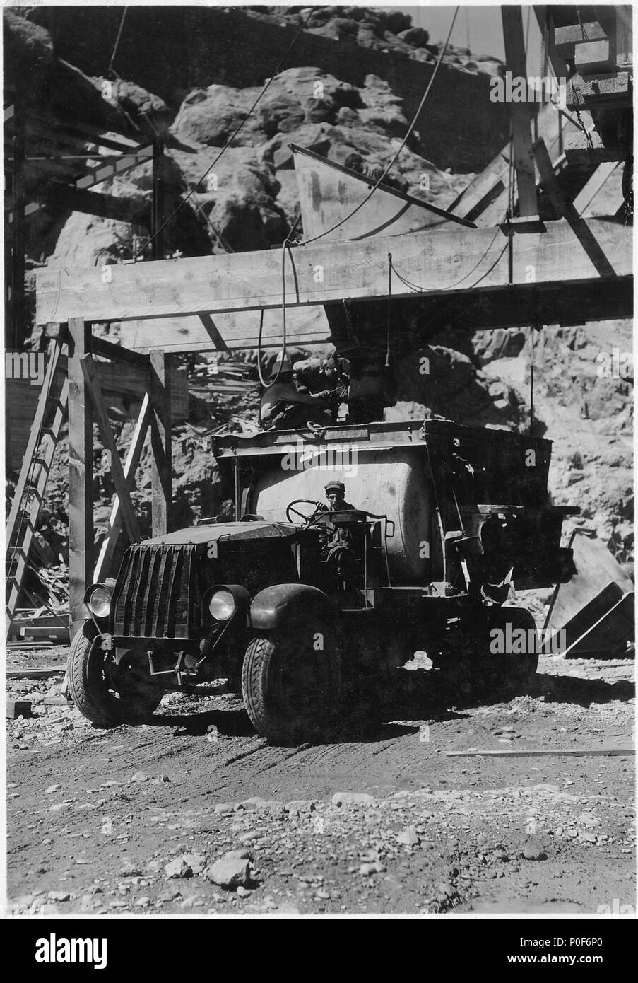 Truck carrying two 4-yard agitators being loaded at Six Companies, Inc., high level concrete mixing plant. Concrete... - Stock Photo