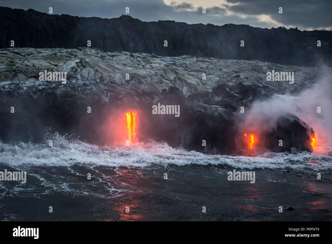 Hot molten lava flowing into the ocean on the Big Island of Hawaii