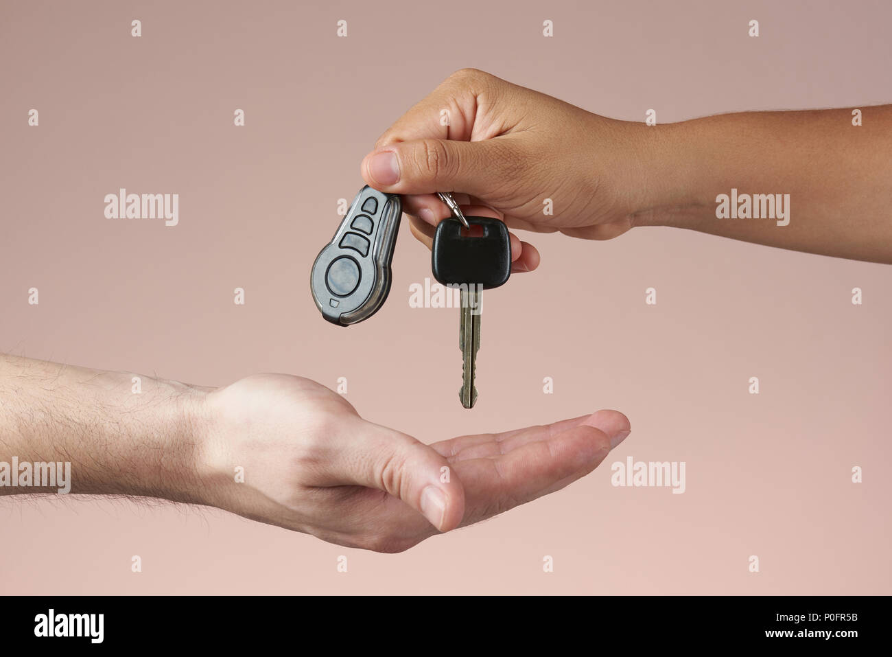 Giving car keys concept. Hand holding auto keys. Sell vehicle service