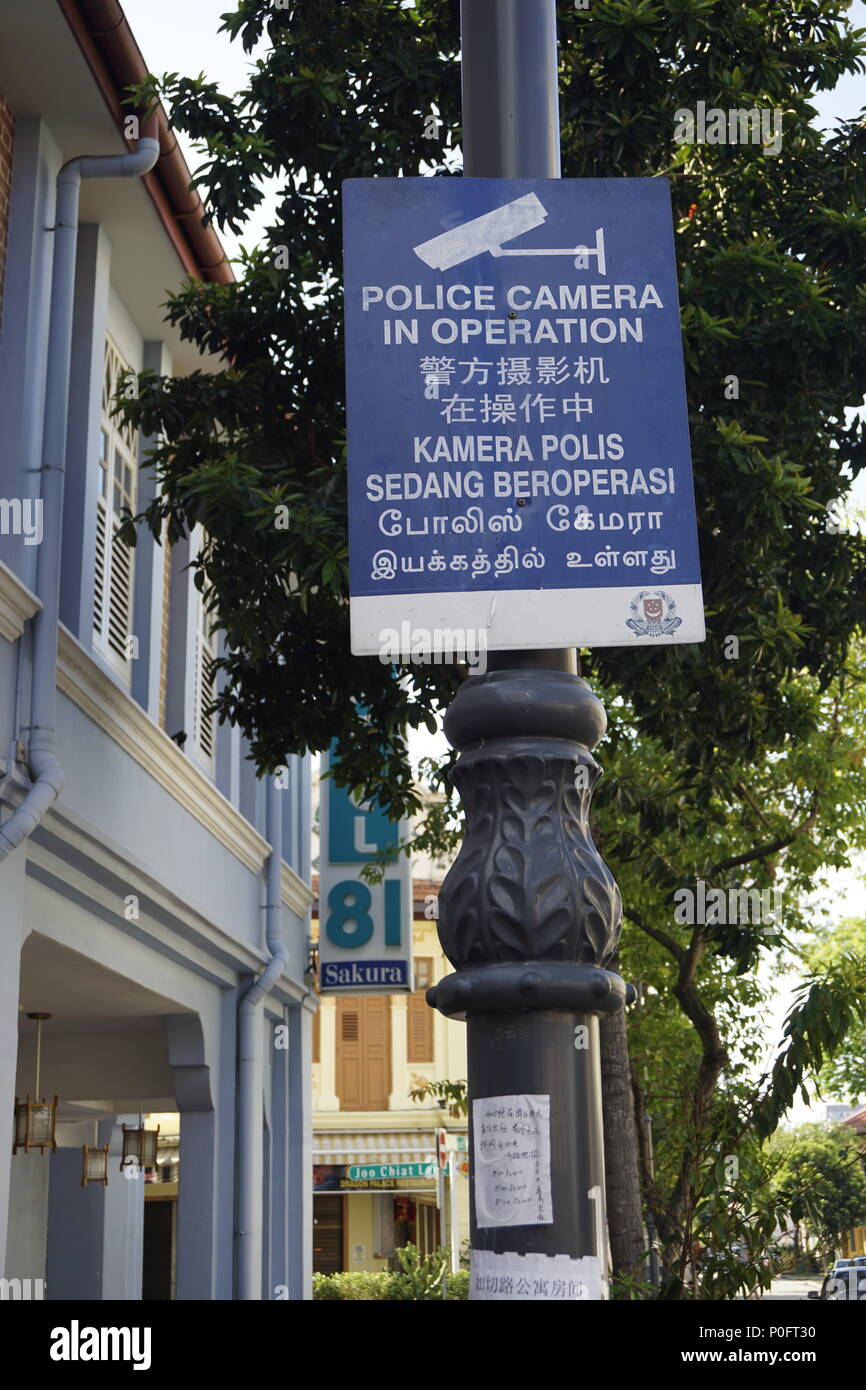 multilingual notice board of police camera in operation in Singapore Stock Photo