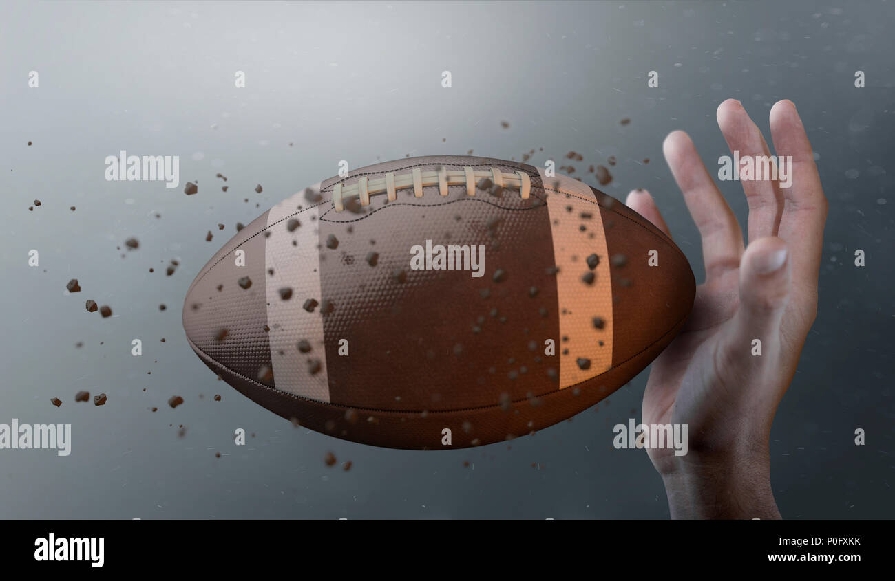 A closeup of an american football ball caught in slow motion flying through the air about to be caught by a dirty hand  - 3D render Stock Photo