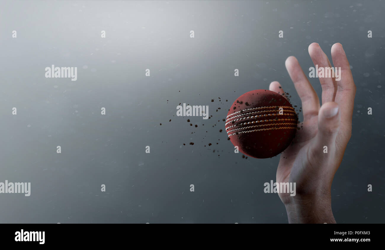 A closeup of a red cricket ball caught in slow motion flying through the air about to be caught