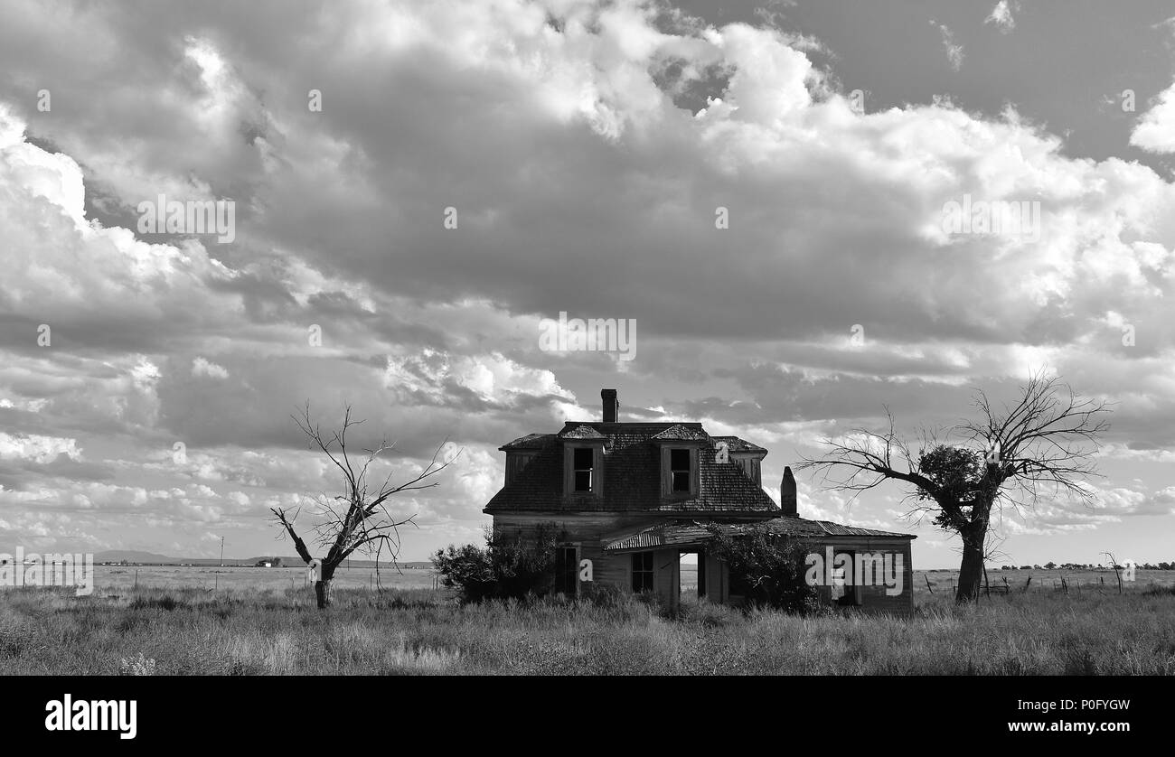 New Mexico back road unveils dilapidated old house with an eerie haunting aura. Stock Photo