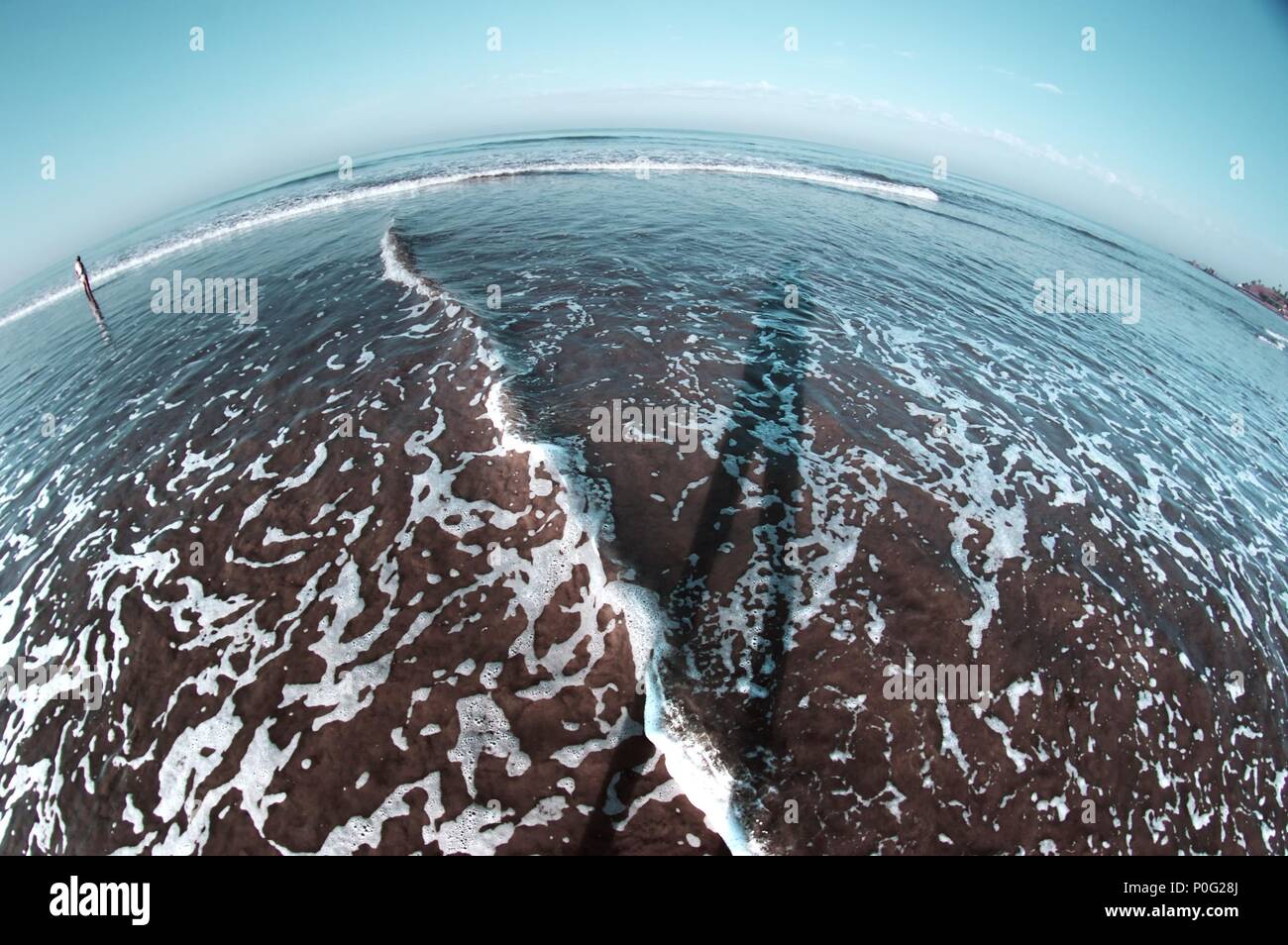 Cold sea with shadow of the human on water. Fish eye Stock Photo