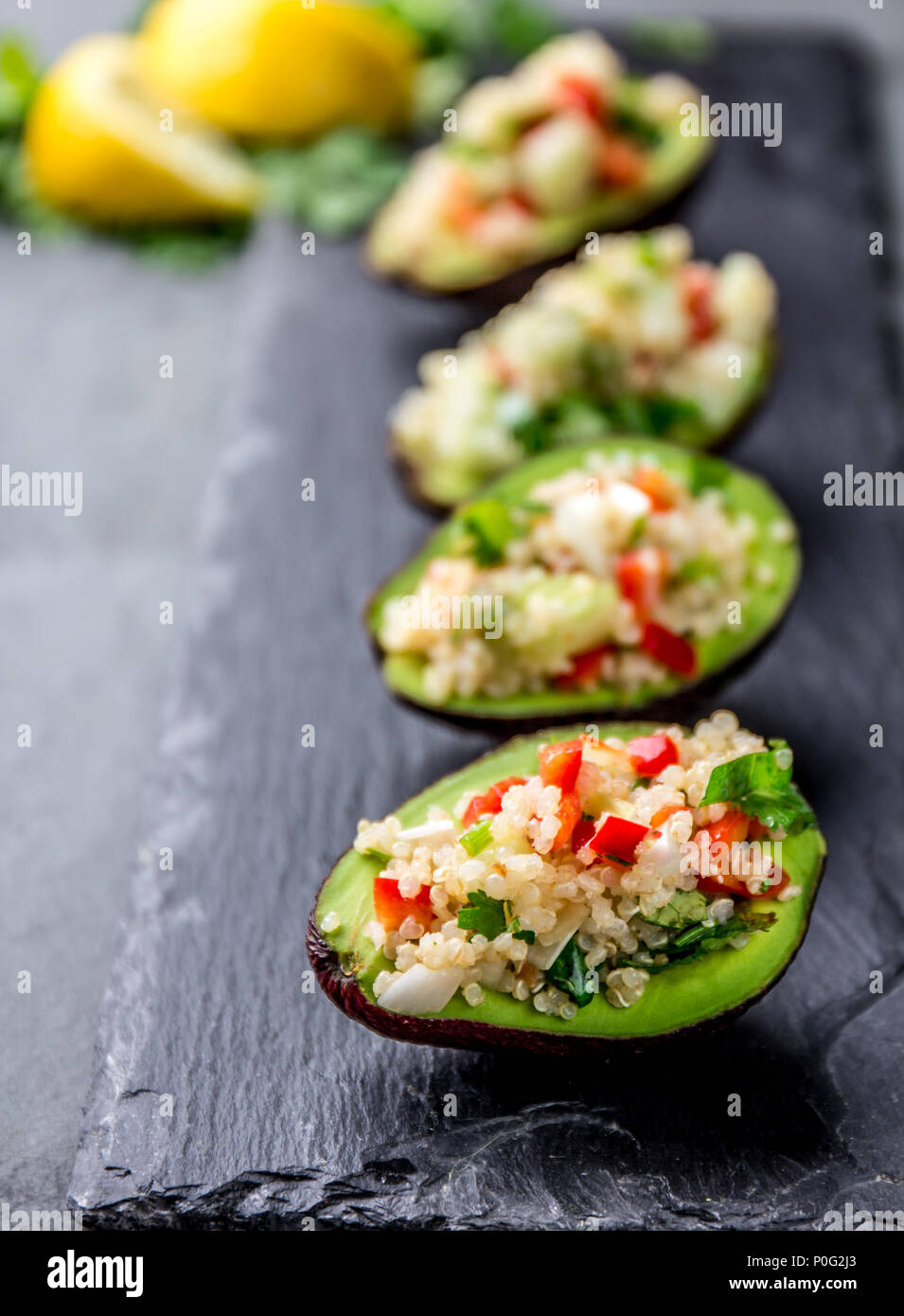 Tradition peruvian quinua quinoa salad served in avocado half, slate