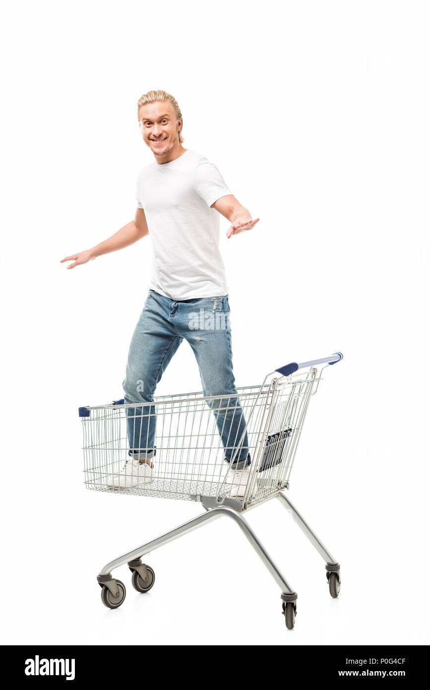smiling man with outstretched arms standing in shopping cart isolated on white Stock Photo
