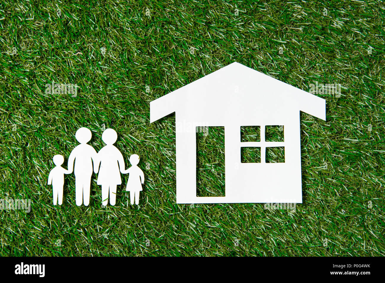 top view of paper figures of family and house on grass Stock Photo - Alamy