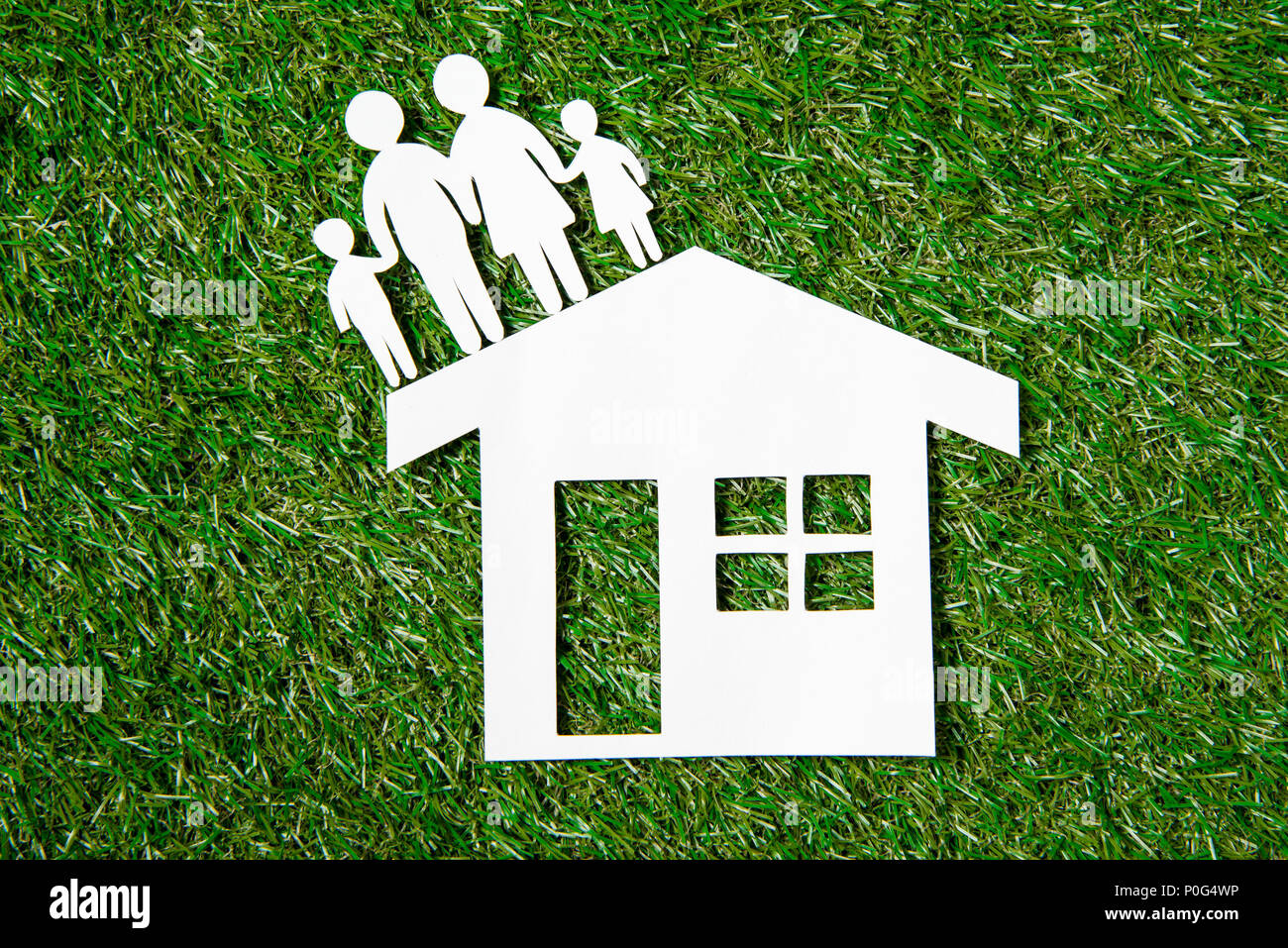 top view of paper figures of family and house on grass Stock Photo - Alamy