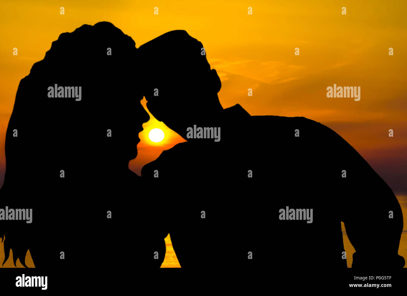 Silhouette of a young couple in love at sunset time Stock Photo - Alamy