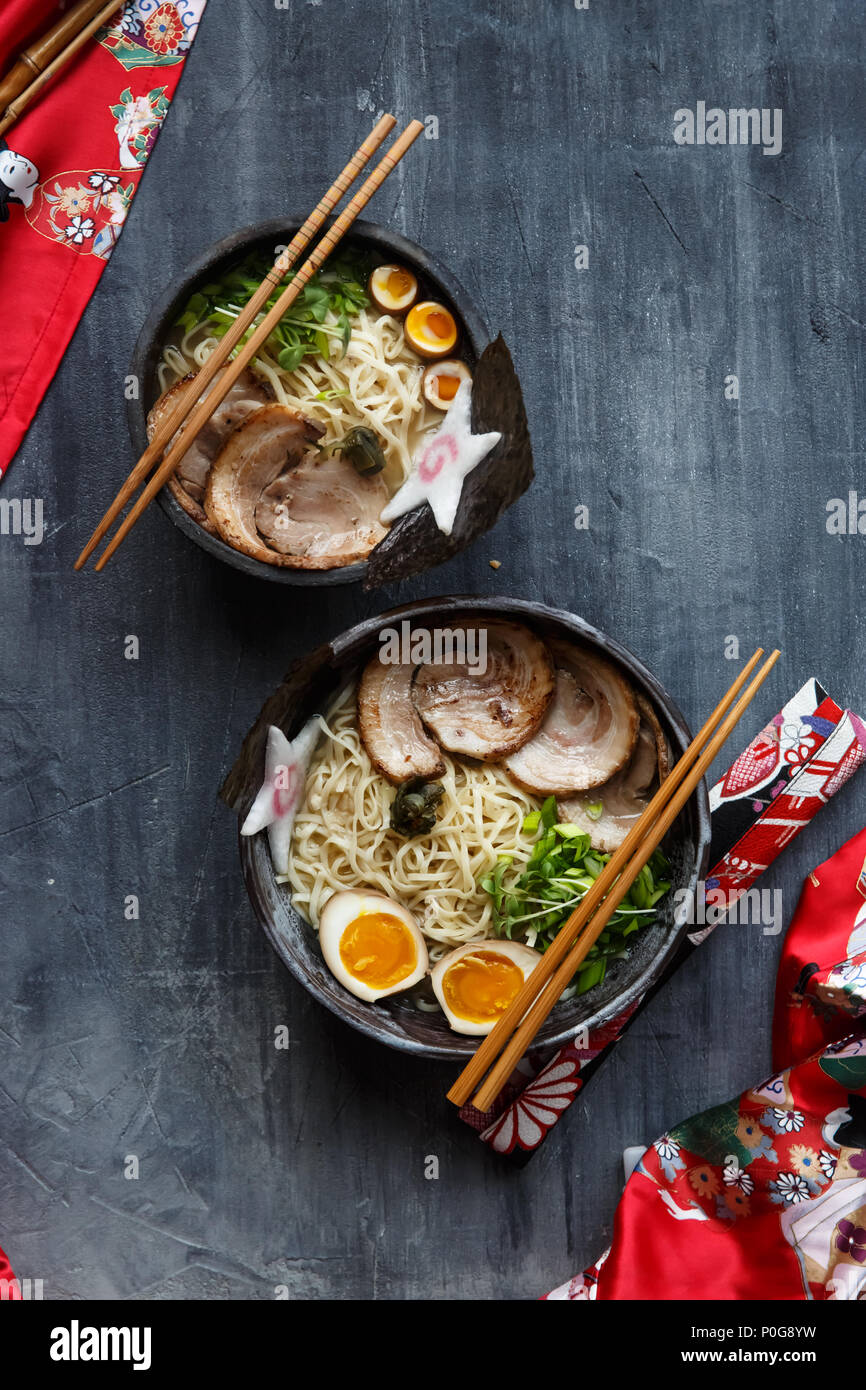 Two ramen bowls with pork, egg and chives, top view Stock Photo Alamy
