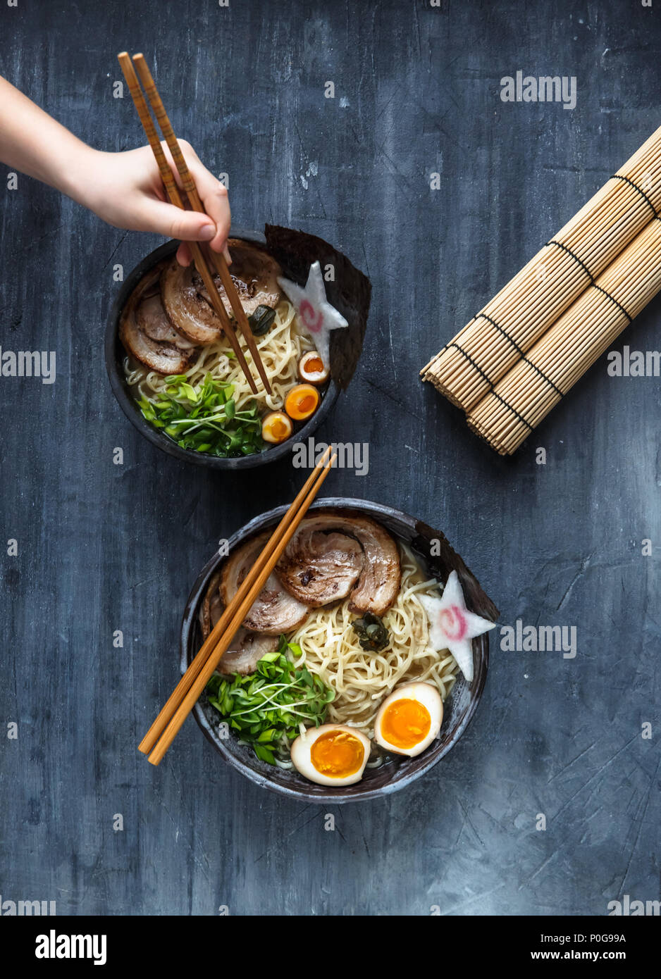 Hand with chopsticks try miso ramen Stock Photo Alamy