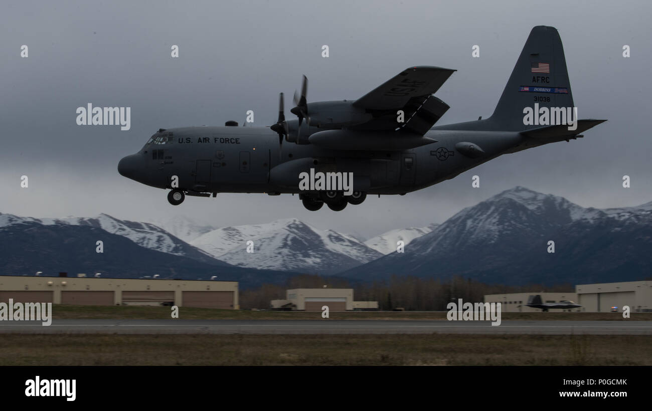 A C-130 Hercules approaches the flightline for landing at Joint Base Elmendorf-Richardson, Alaska, May 10, 2018. The C-130 can accommodate a wide variety of oversized cargo, including utility helicopters and six-wheeled armored vehicles to standard palletized cargo and passengers. In an aerial delivery role, it can airdrop loads up to 42,000 pounds or use its high-flotation landing gear to land and deliver cargo on rough, dirt strips. (U.S. Air Force photo by Senior Airman Curt Beach) Stock Photo