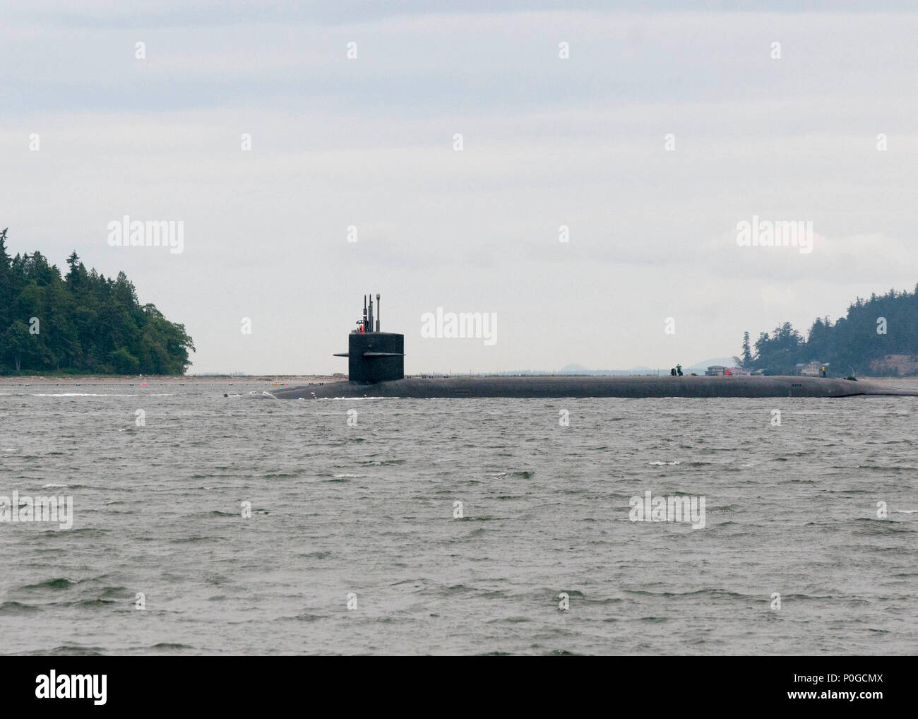 HOOD CANAL, Wash. (June 7, 2018) The Blue crew of the Ohio-class ballistic missile submarine USS Kentucky (SSBN 737) transits the Hood Canal as the boat returns to its homeport at Naval Base Kitsap-Bangor, Wash., following a routine strategic deterrent patrol. Kentucky is one of eight ballistic-missile submarines stationed at Naval Base Kitsap-Bangor providing the most survivable leg of the strategic deterrence triad for the United States. (U.S. Navy photo by Lt. Cmdr Michael Smith/Released) Stock Photo