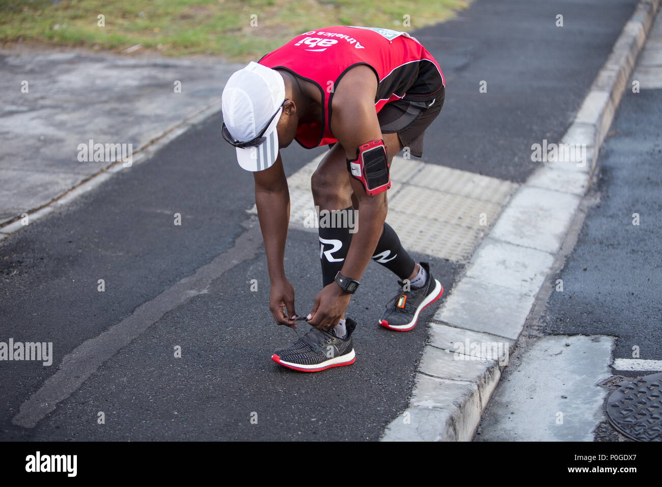 A two oceans endurance runner stops to tie up his shoe laces Stock Photo