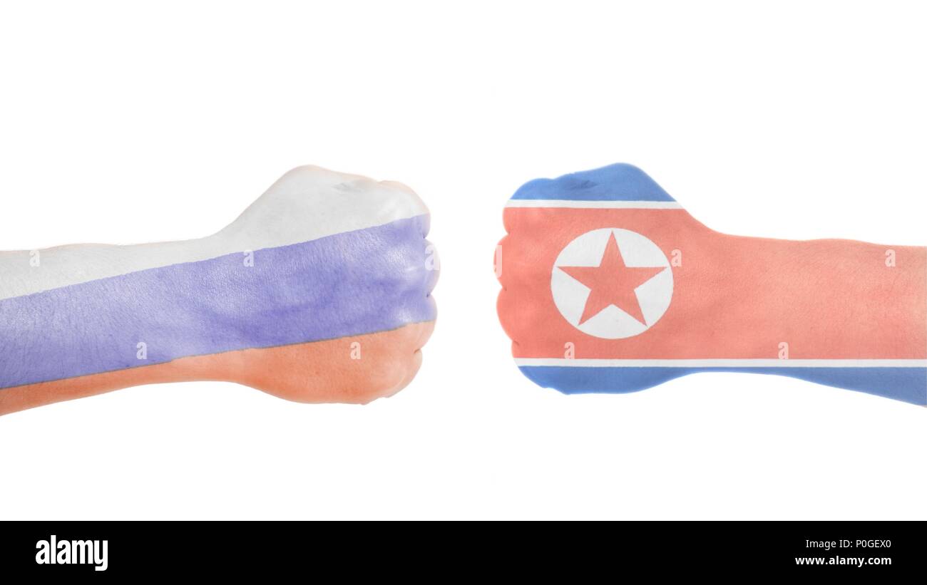 North Korean and Russian flags painted on two clenched fists isolated white background Stock Photo