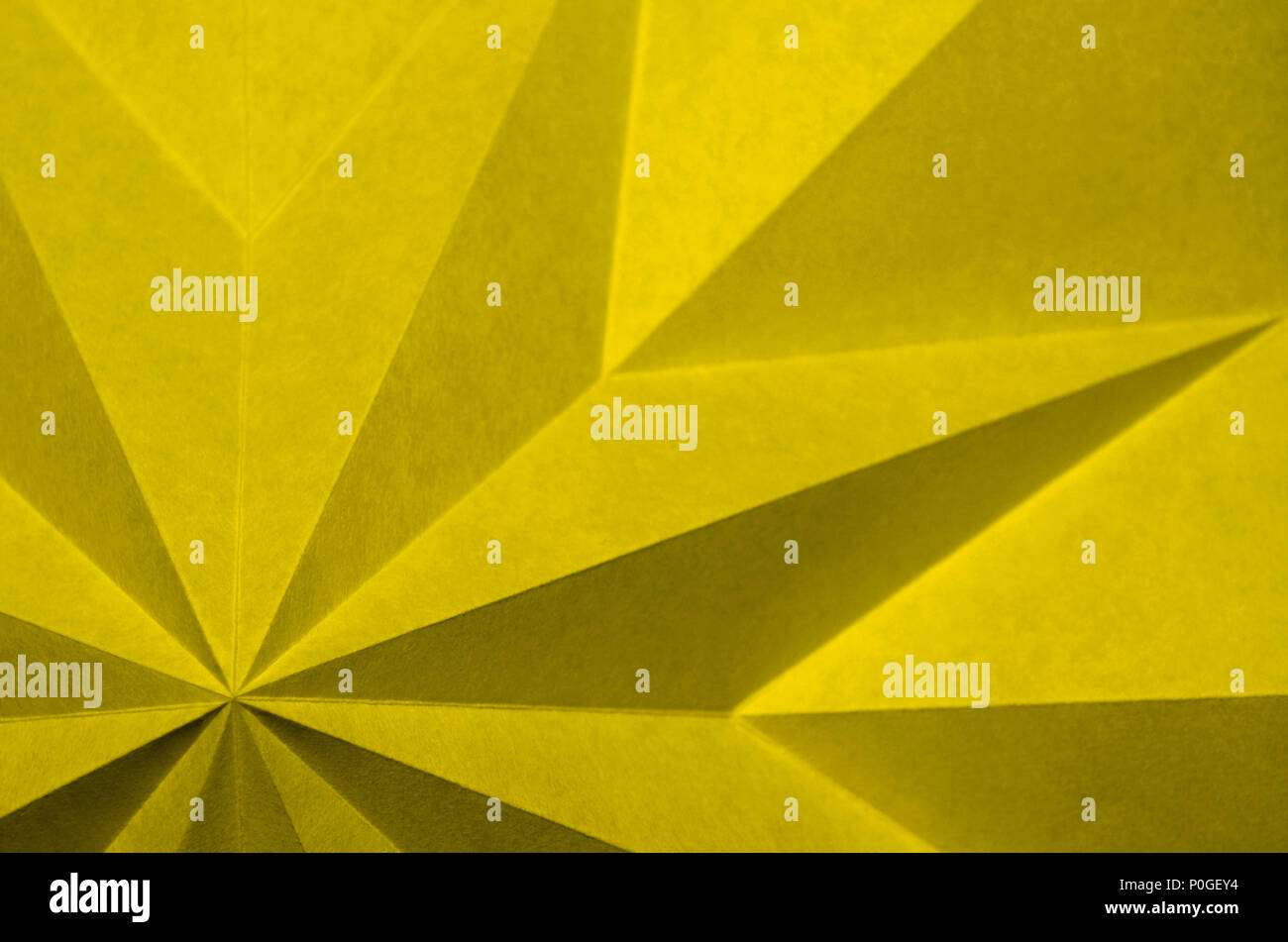 yellow origami abstract background wallpaper. Pantone 13-0646; Meadowlark, Pantone 2018 color of the year compliment. Stock Photo
