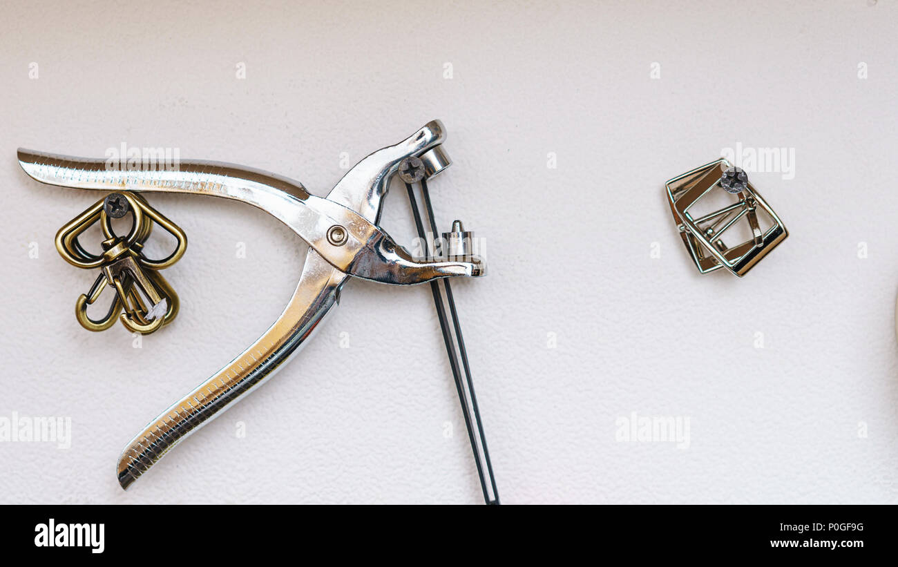 Tool of a tanner close-up. The rivet on the table Stock Photo - Alamy