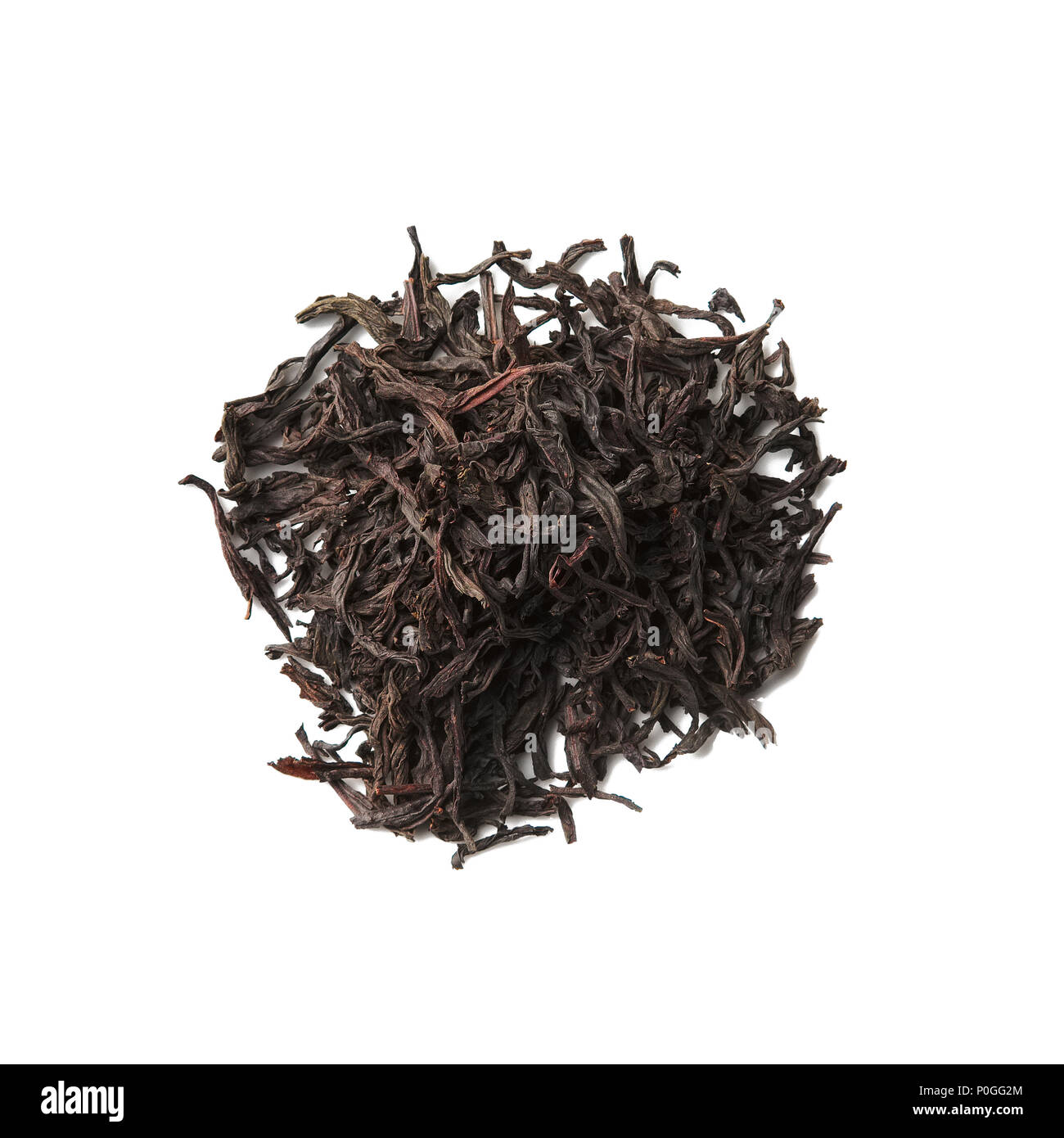 Heap of dried herbal tea leaves isolated on white. Top view of tea Legends of England. Stock Photo