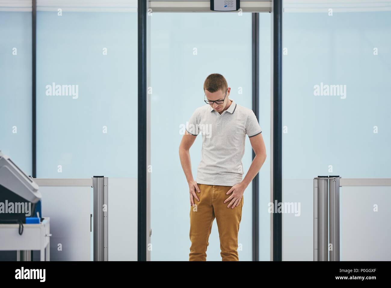 Airport security check. Young man (traveler) in gate of the metal detector. Stock Photo