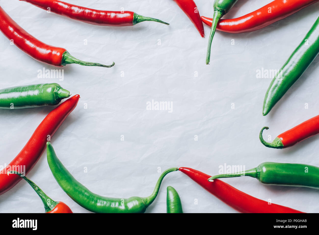 top view of red and green chili peppers on white tabletop Stock Photo ...