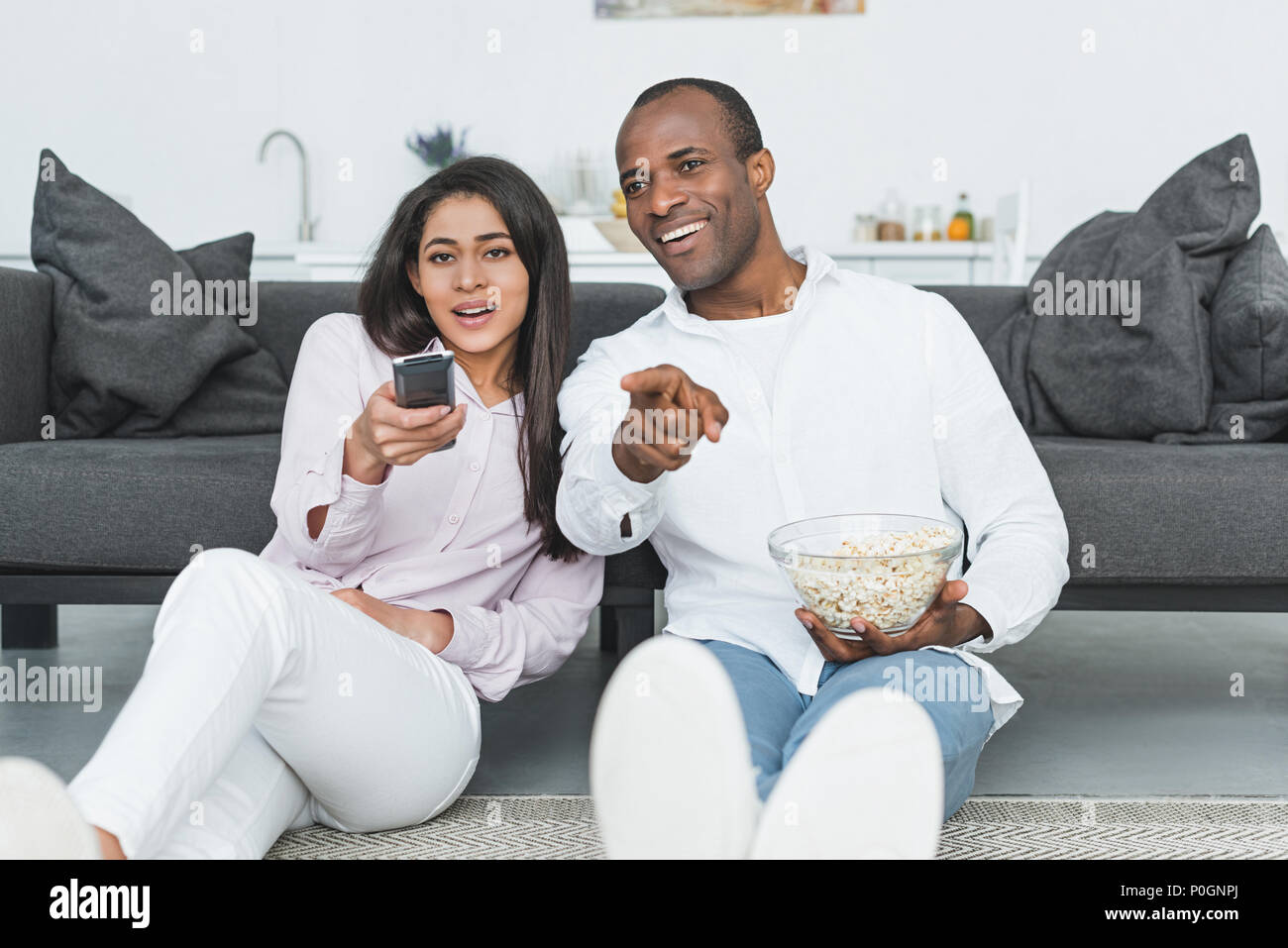happy african american couple watching tv with popcorn at home Stock ...