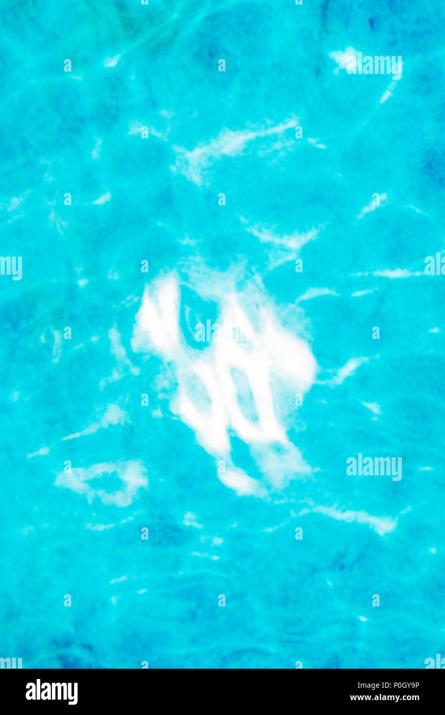 Reflected sunlight creates abstract patterns in outdoor swimming pool Stock Photo