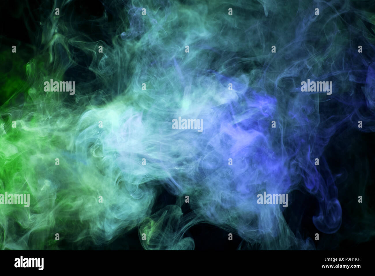 Thick green and blue smoke on a black isolated background. Background ...