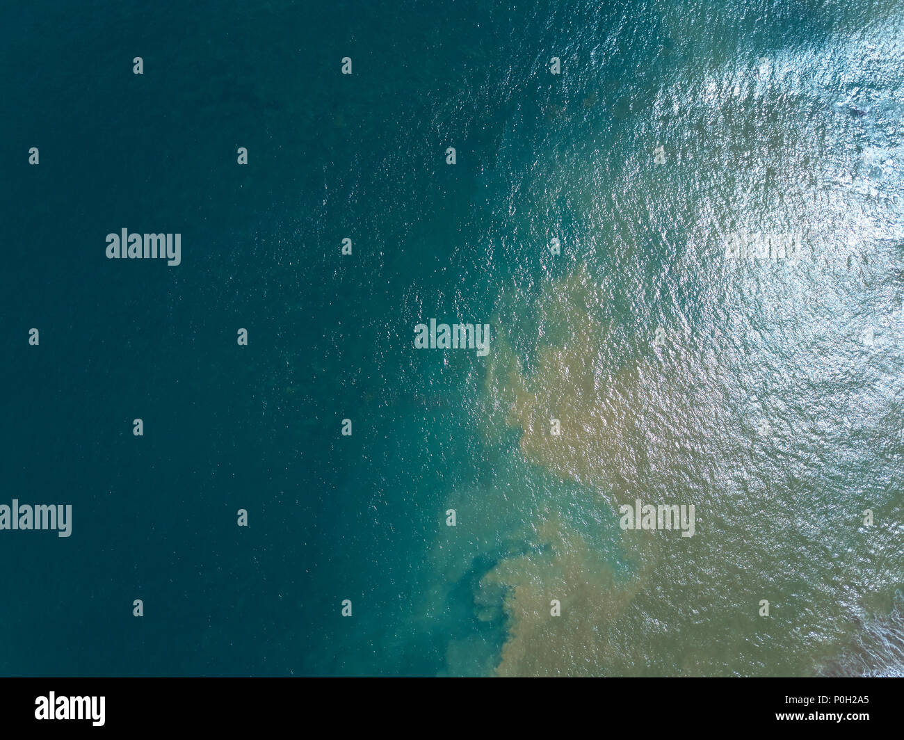 Green ocean water mix with brown river view from above Stock Photo