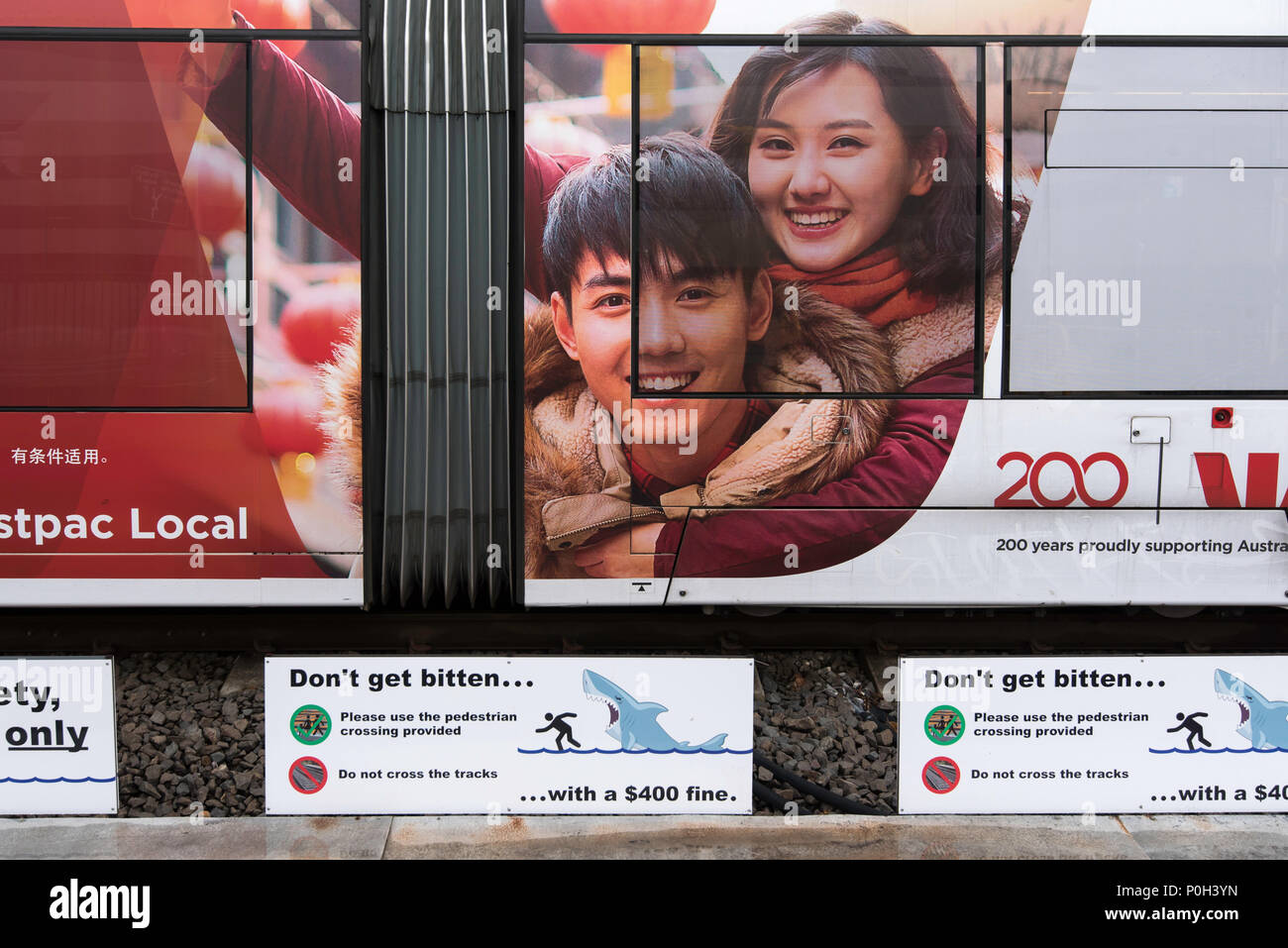 Westpac Bank advertising on the side of a Sydney Light Rail train or tram at the Exhibition Centre station in Sydney, Australia Stock Photo