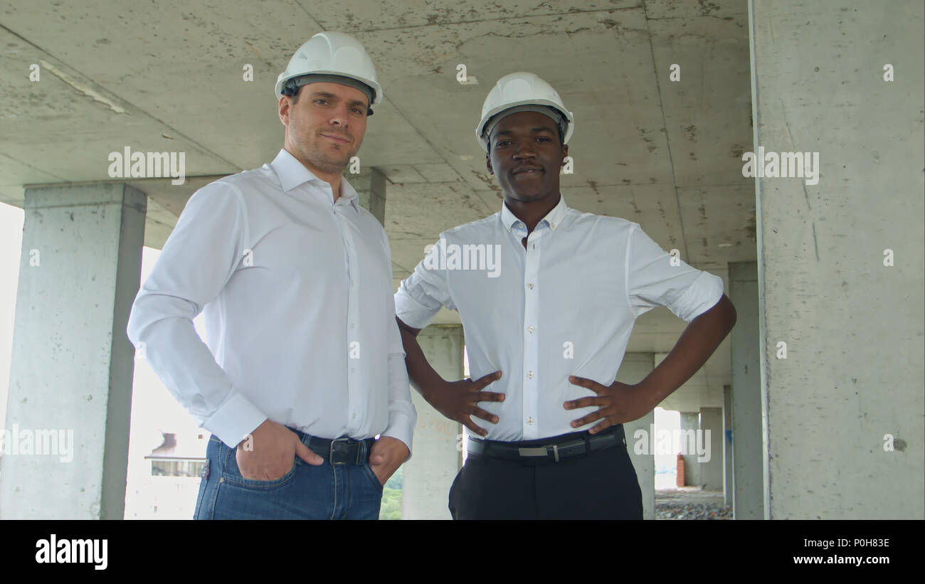 Architectural team smiling at the camera with hard hats Stock Photo - Alamy