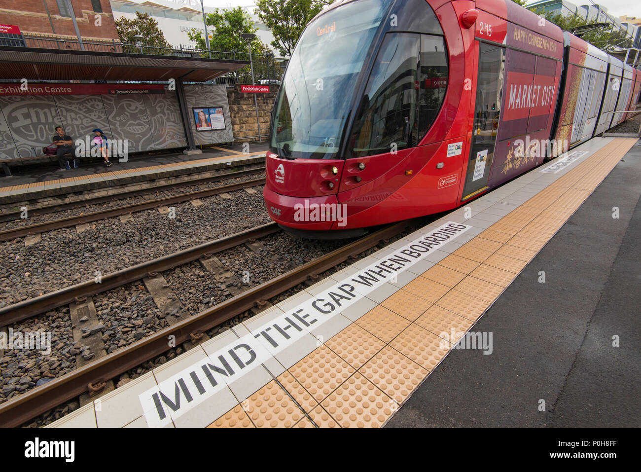 A Mind the Gap warning sign on the platform of a Sydney Light Rail train or tram at the Exhibition Centre station in Sydney, Australia Stock Photo