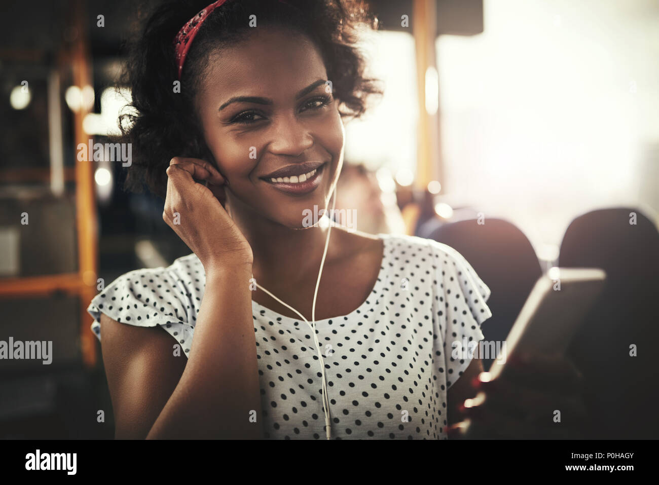 Smiling african female listening hi-res stock photography and images ...