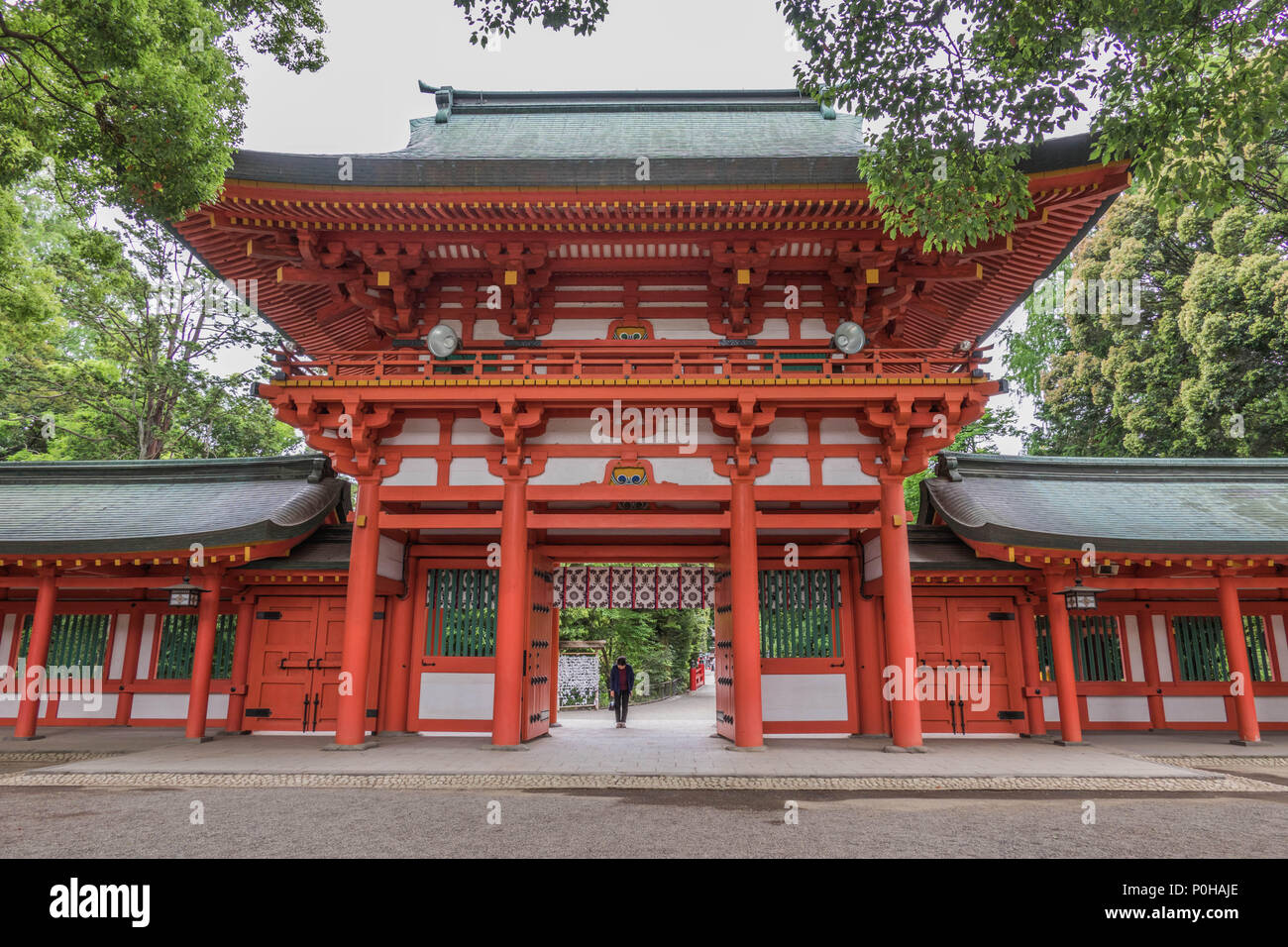Man bowing  at temple gate  before entering, Hikawa Jinja shrine, Omiya, Saitama, Japan Stock Photo
