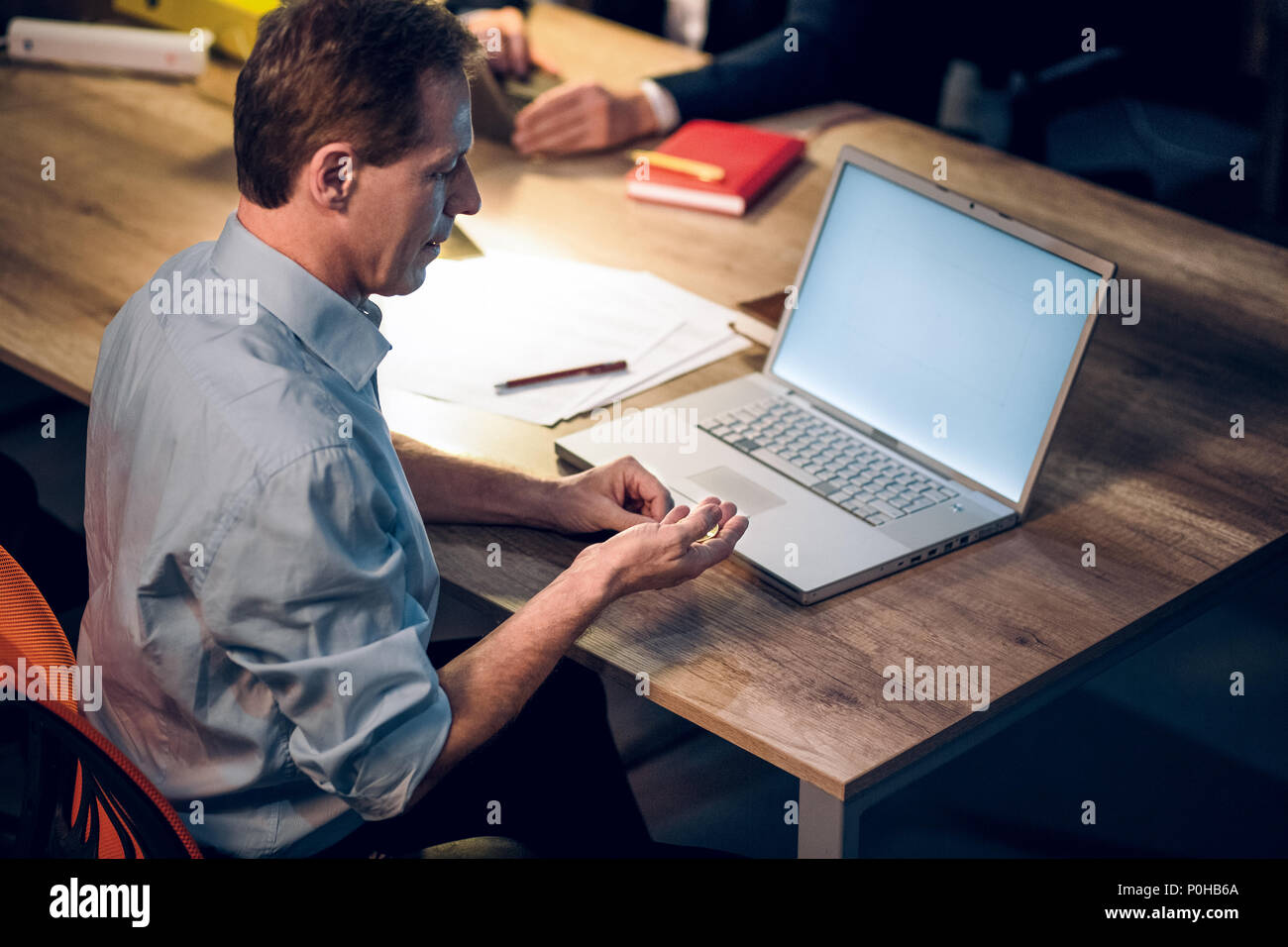 Businessman with bitcoin in office Stock Photo - Alamy